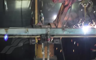 Cobot welding arm with sparks | American Manufacturing